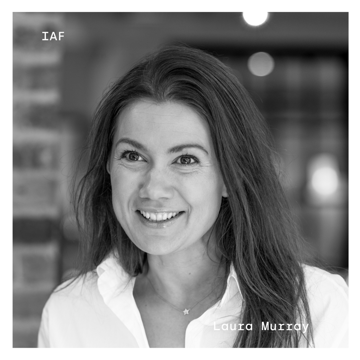 Black and white profile of Laura Murray. Her name is in white in the bottom right corner, and "IAF" in white in the top left corner.